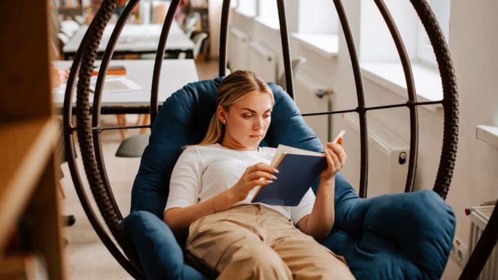 Woman relaxing alone at a café with a book.