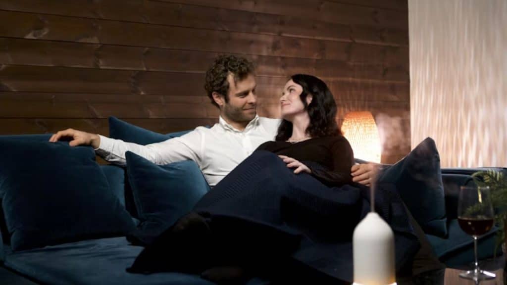 Couple sitting on couch having a meaningful talk.