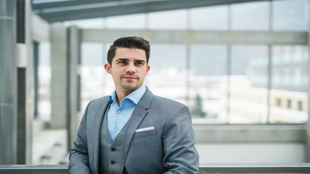 A businessman standing on a corridor.