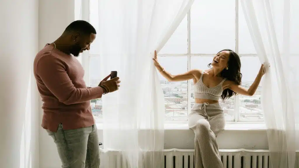 A man taking his wife’s photo.