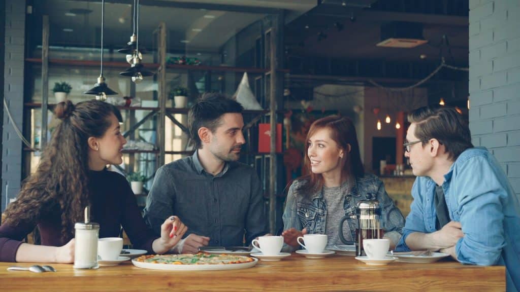 Friends talking at a restaurant.
