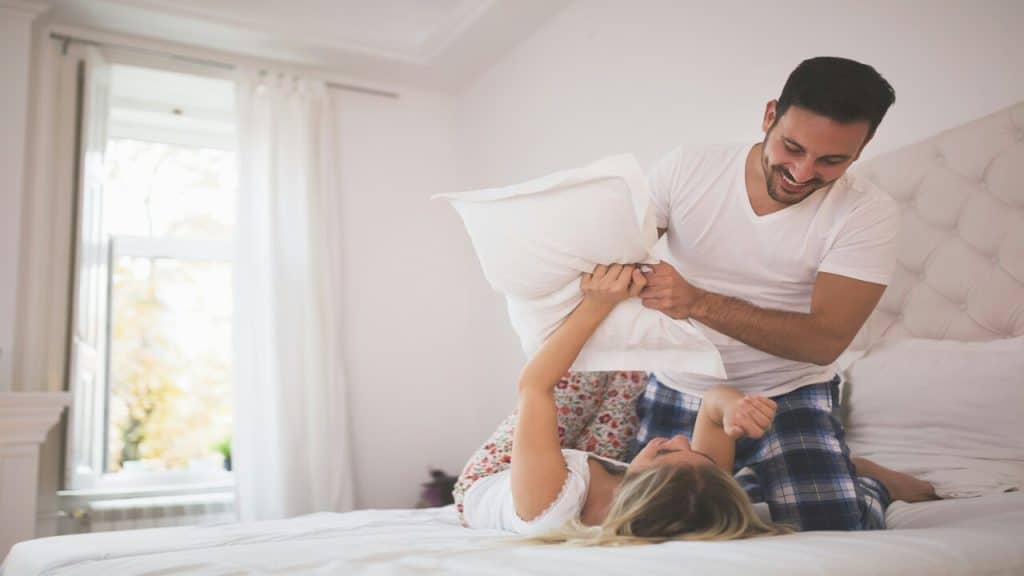 A couple having a pillow fight.