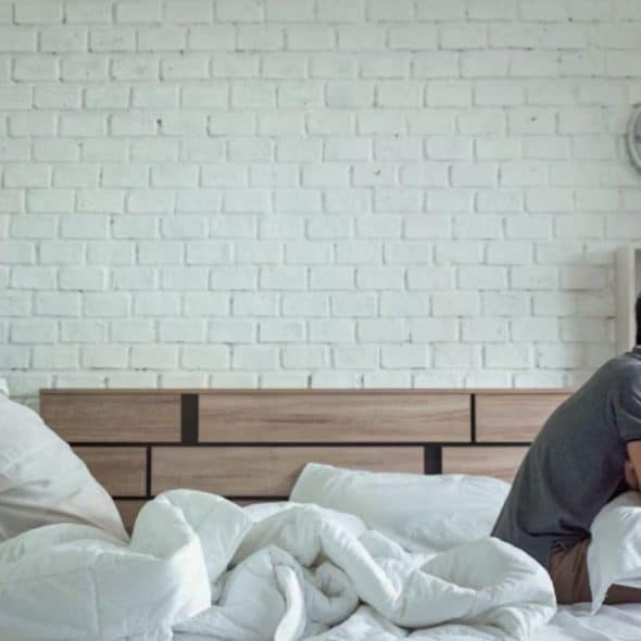 Couple sitting in the same room, emotionally distant but not arguing