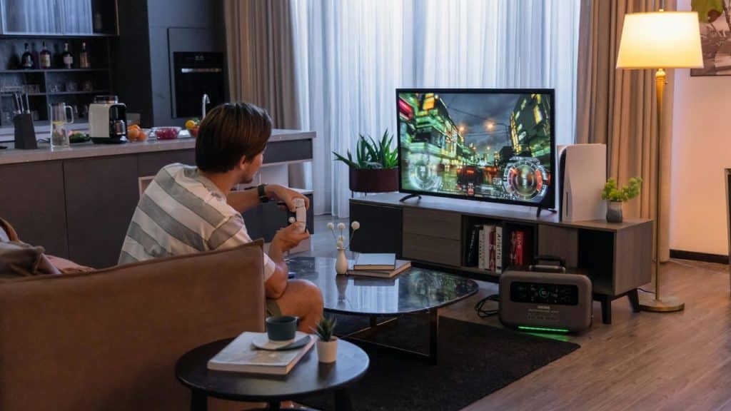 A person is sitting on a couch and playing a video game.
