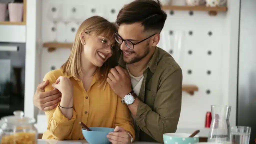 Man holding his partner’s shoulder at the dinner table