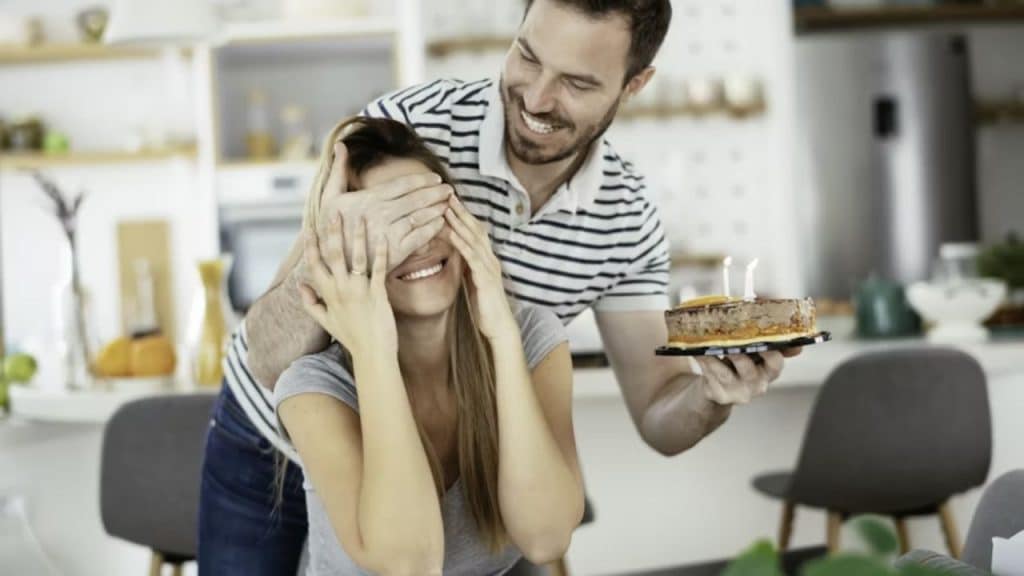 Man surprising his wife on her birthday