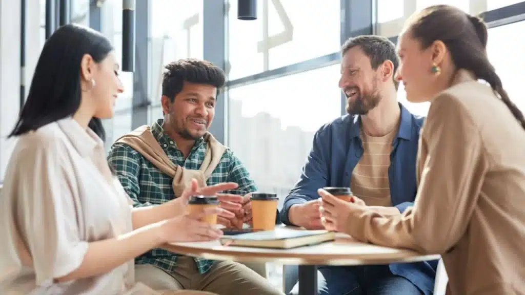 Woman smiling while talking about her partner over coffee with friends