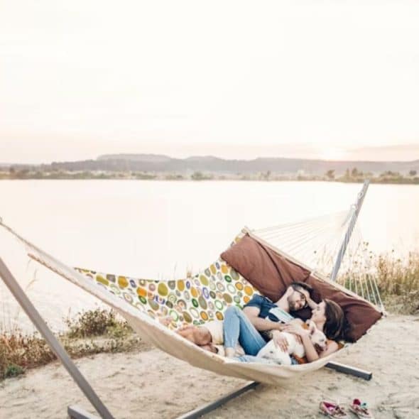 Couple cuddling and relaxing in hammock