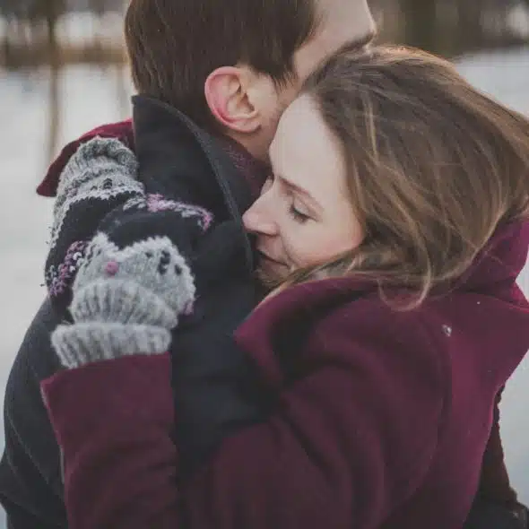 A man and woman hugging each other
