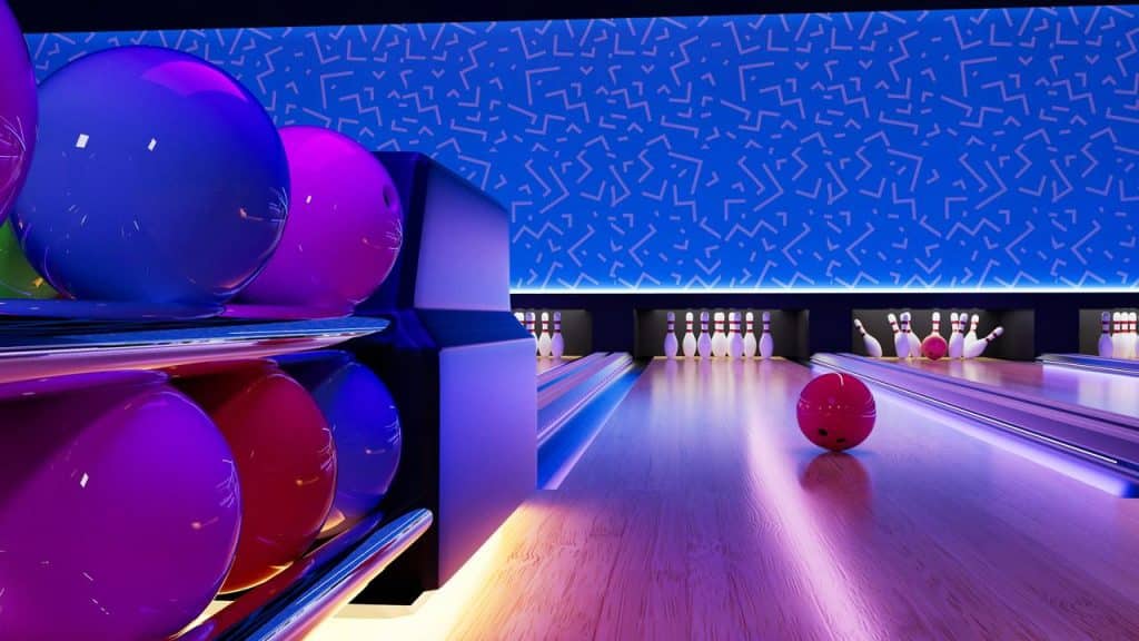 A brightly lit bowling alley with colorful bowling balls and pins.