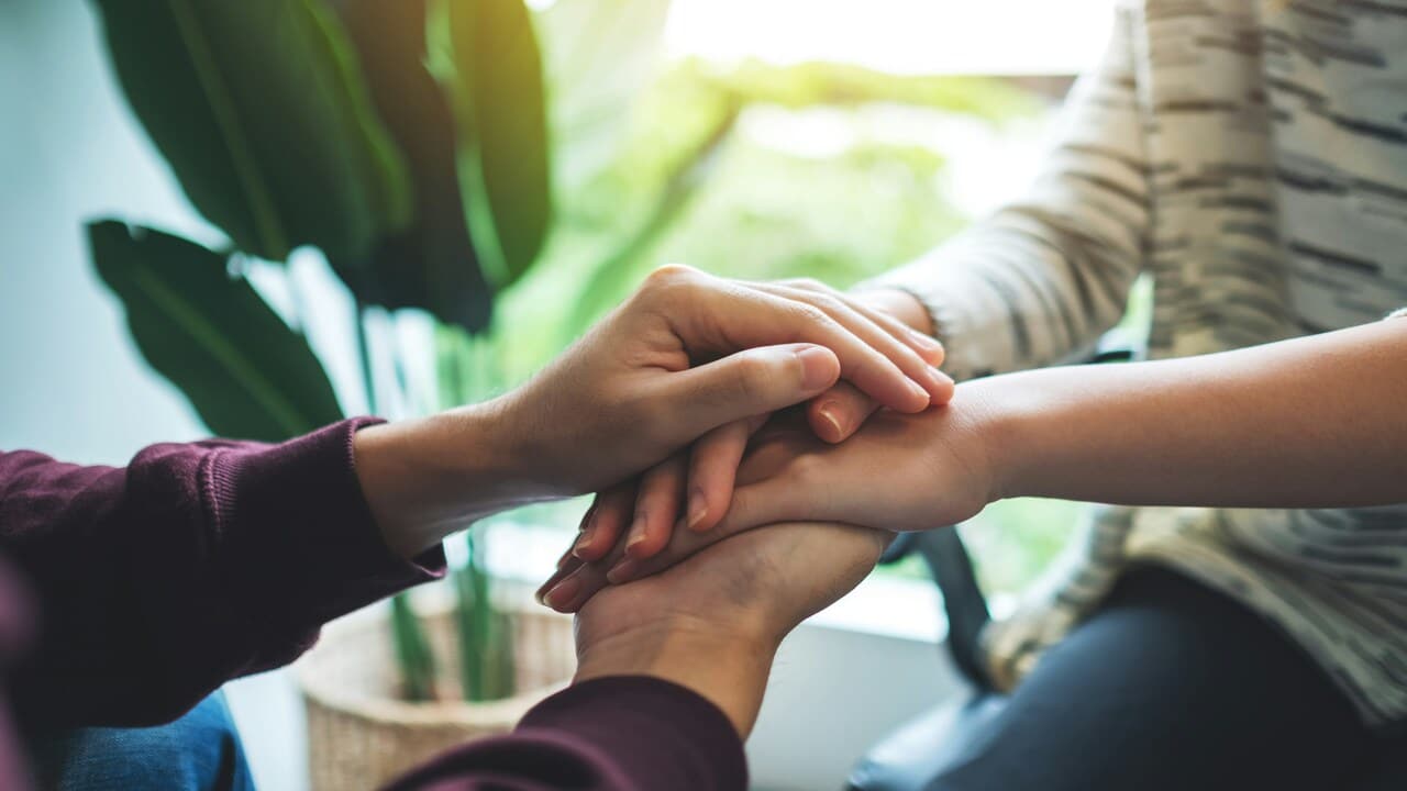 A couple holding hands.