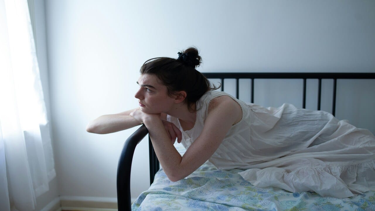 A woman looking bothered at home.