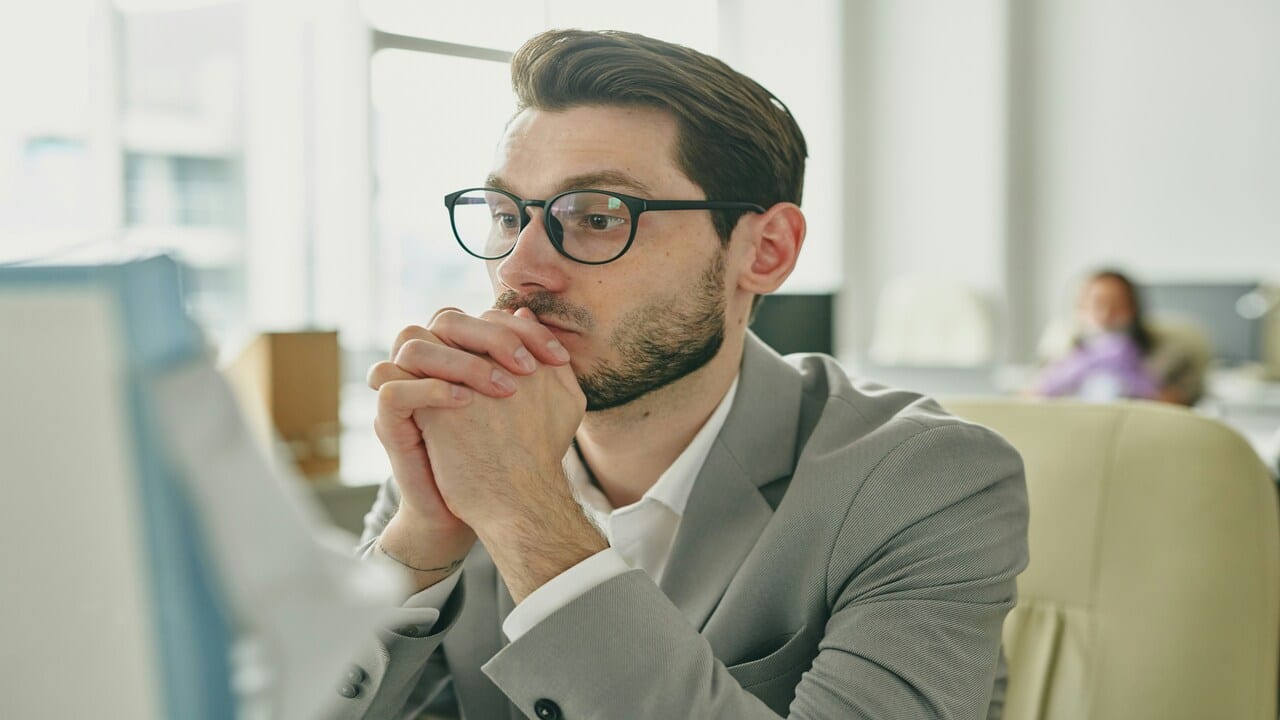A man looking uneasy at work.