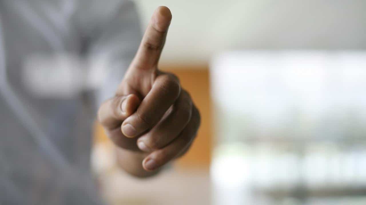 A person's hand pointing in a certain direction.