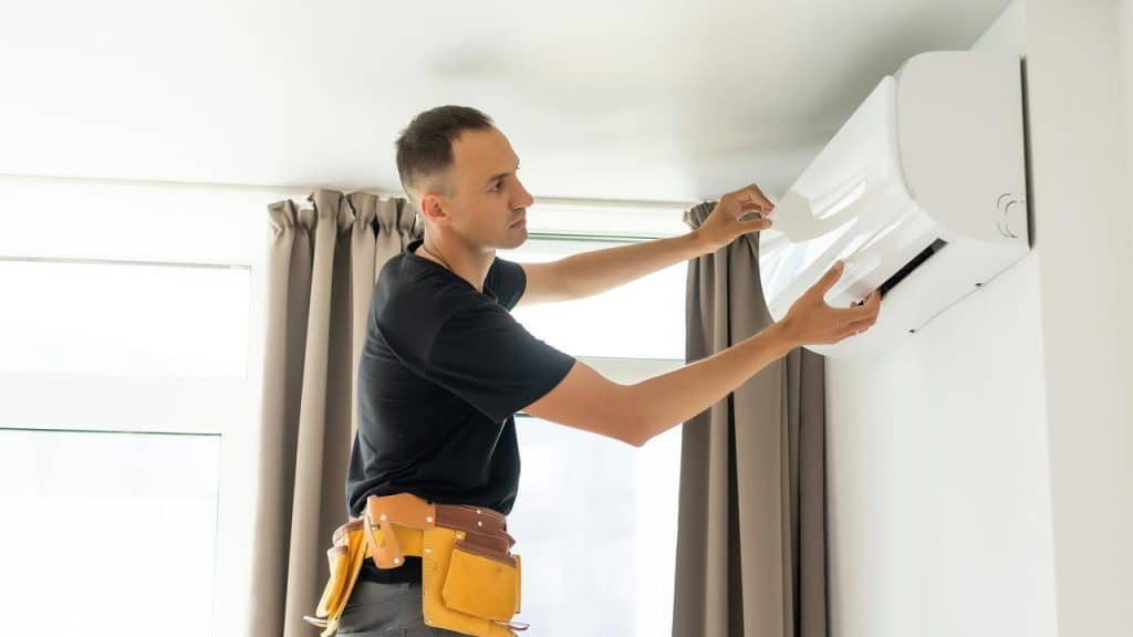 A technician servicing an air conditioner.