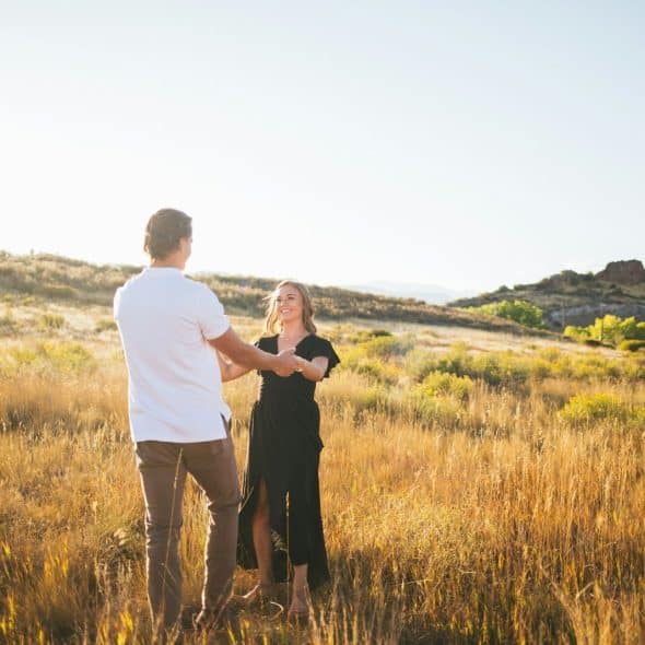 A man and woman at the grass field