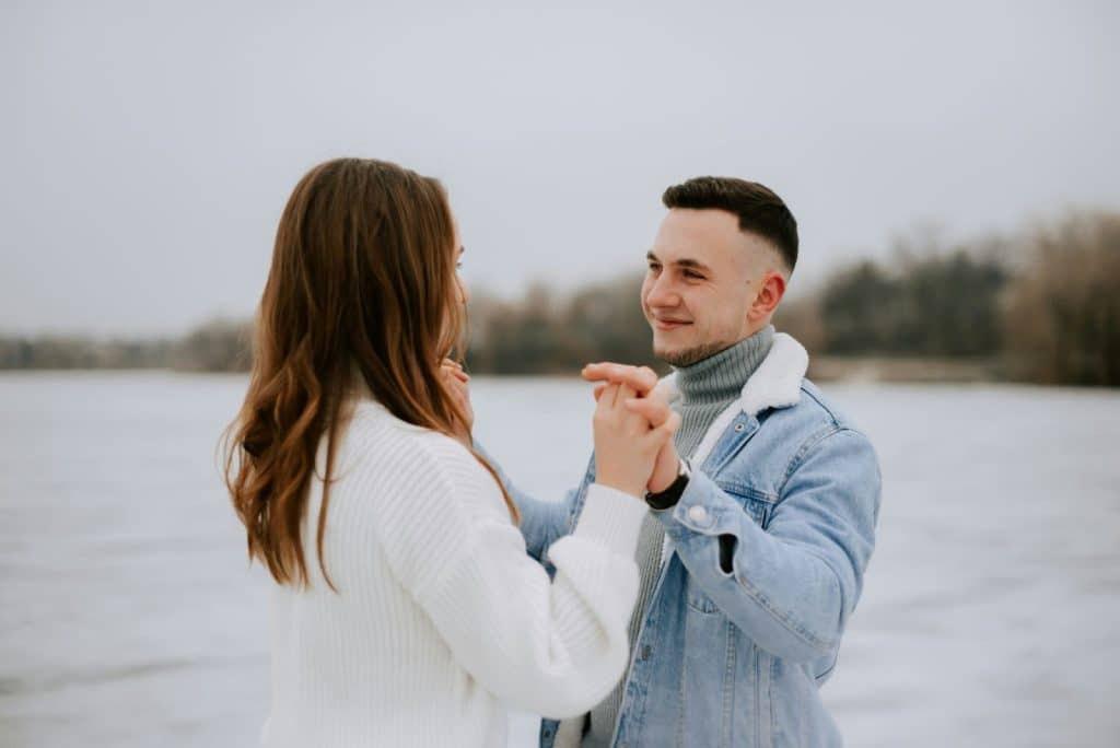A man and woman looking at each other while smiling