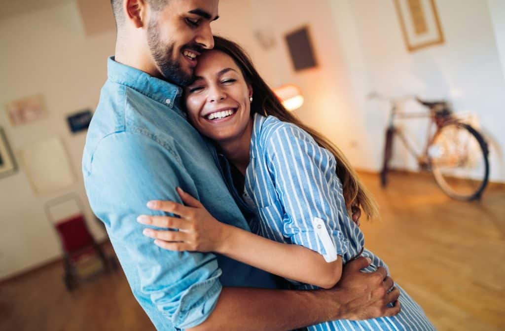 A woman hugging a man