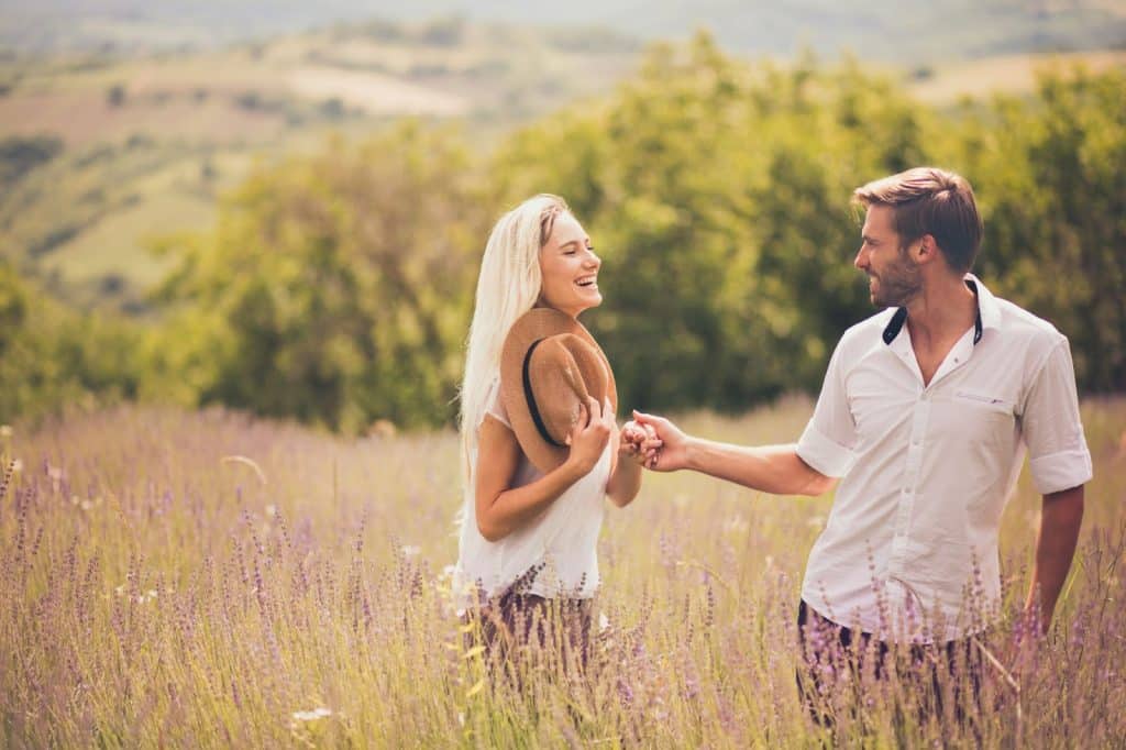 A man and woman at the grass field