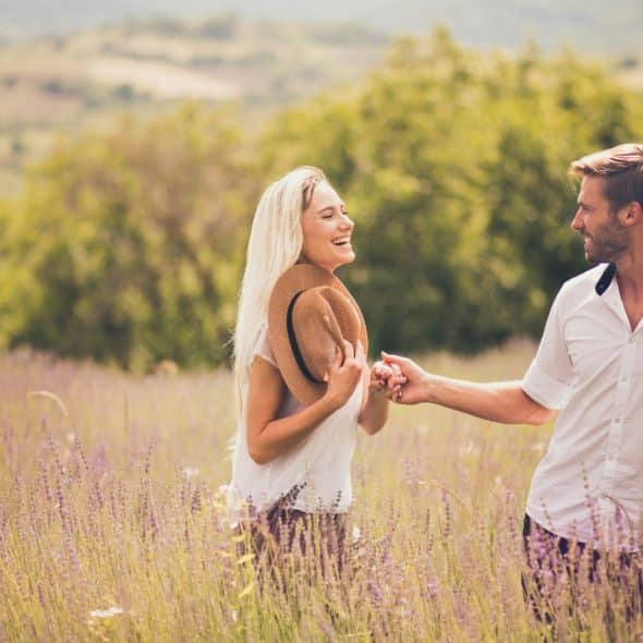 A man and woman at the grass field