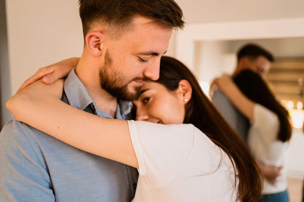 A woman hugging a man