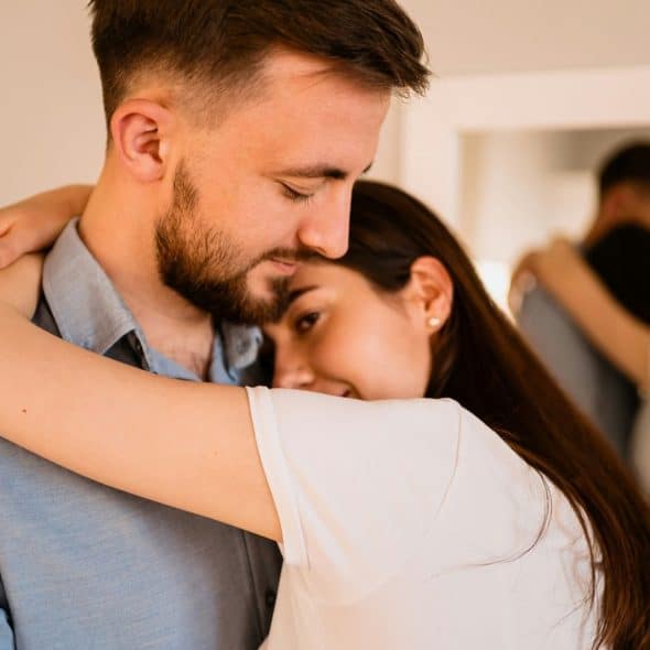 A woman hugging a man