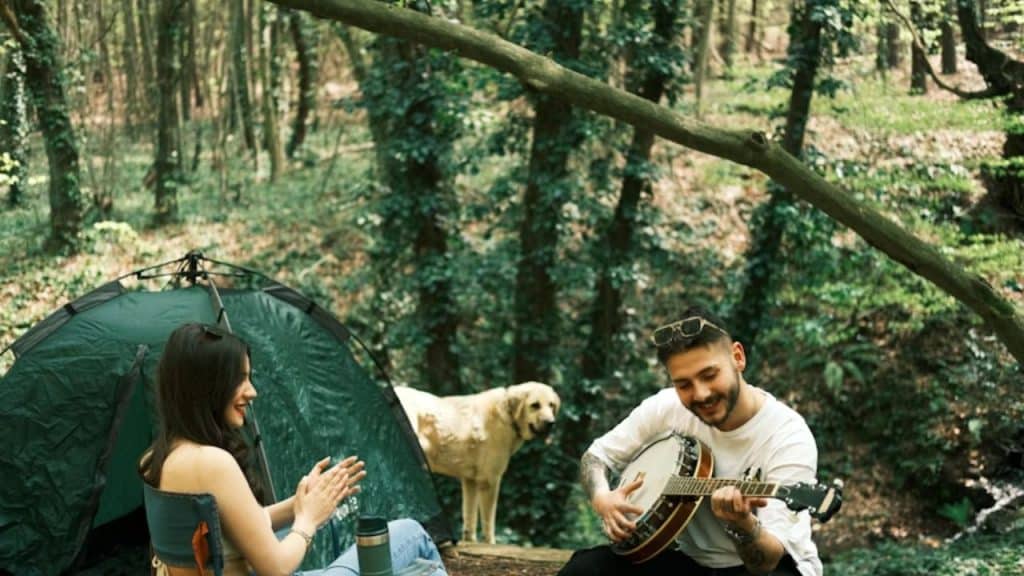 A Couple enjoying music in a scenic national park wooded setting.