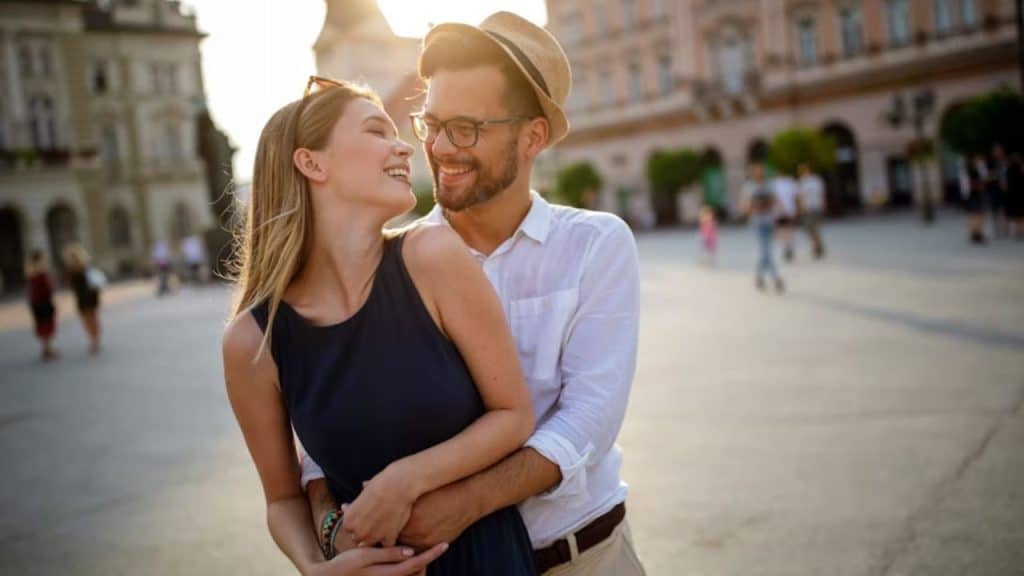 Couple walking through a historic, charming street with aged buildings