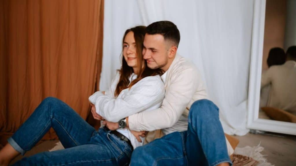 A man embracing his partner in a comforting way