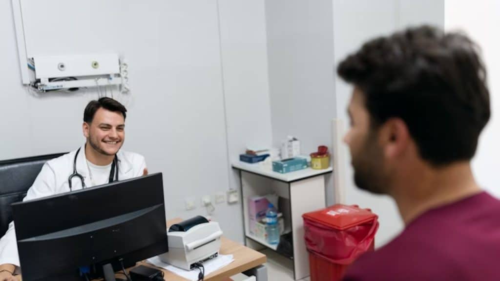 Man speaking with doctor in clinic