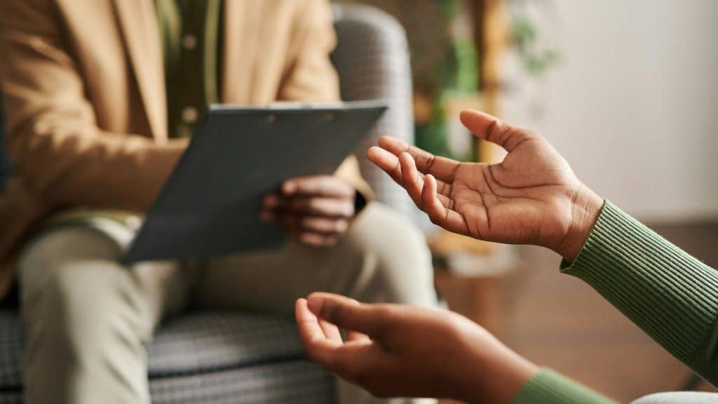 A person gesturing during a counseling session.
