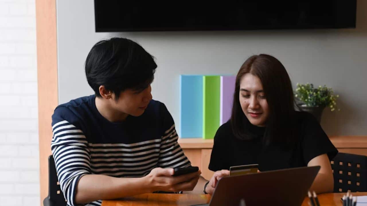 Couple reviewing a monthly budget together.
