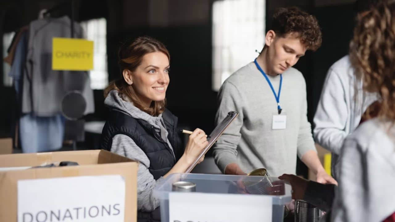 Couple donating clothes and food at a local charity center.