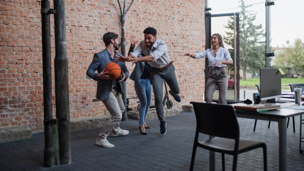 Man playing basketball with friends while his partner cheers.