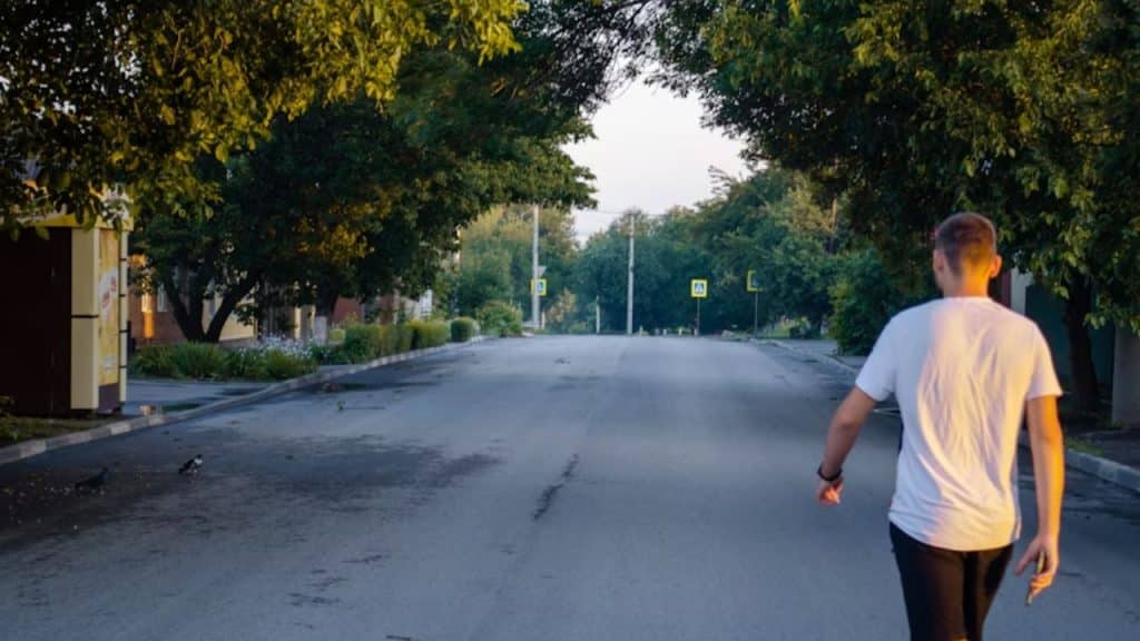 Man stepping outside to take a walk alone