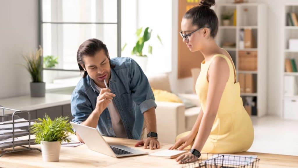 Couple writing notes together at a table