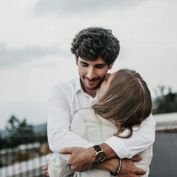 A woman hugging a man