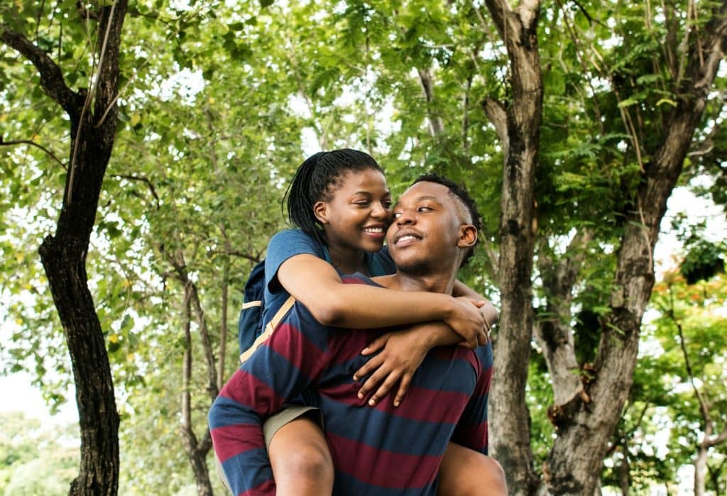 A man carrying a woman on his back