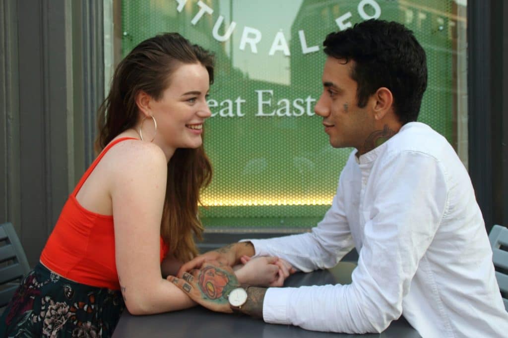 A man and woman facing each other