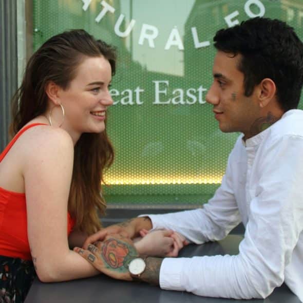 A man and woman facing each other