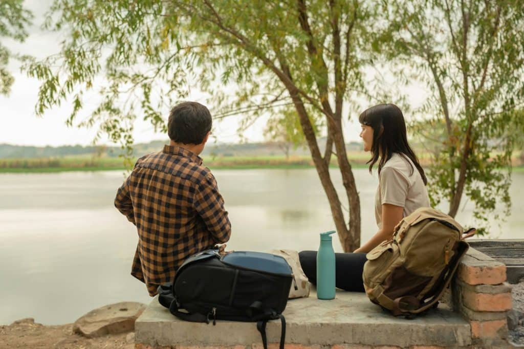 A man and woman talking while at the park