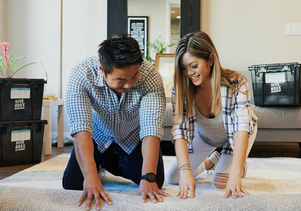 A man and woman cleaning the floors