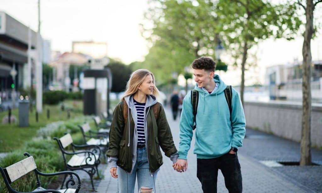 A man and woman walking outside