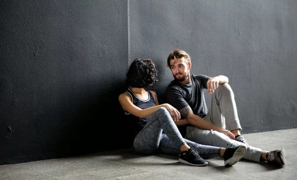 A man and woman talking while at the floor