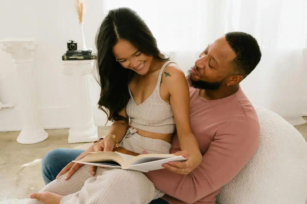 A man and woman reading a book together