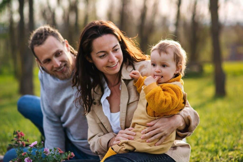 A man and woman being a parent to a kid