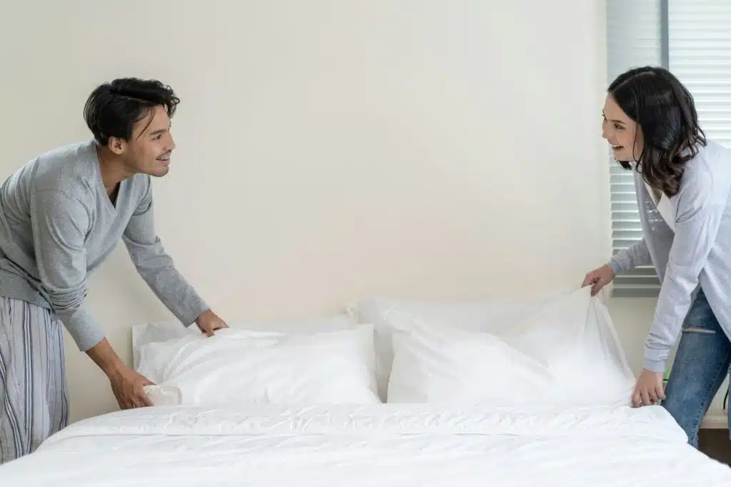 A married couple folding their blanket