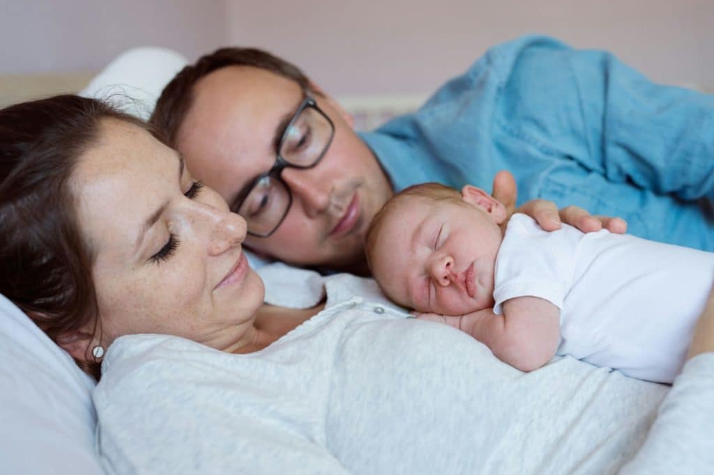 A man and woman with their newborn