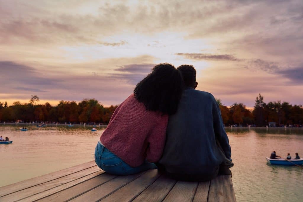 A man and woman looking at the boats