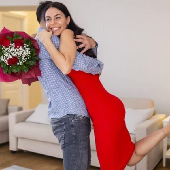 Couple hugging and enjoying time together while celebrating success